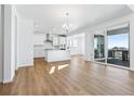 Open concept kitchen features white cabinets, stainless steel appliances, and an island at 9324 Quartz St, Arvada, CO 80007