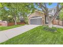 Charming home with a stone-accented garage, lovely landscaping, and inviting curb appeal at 16341 Maple Rock Ct, Parker, CO 80134