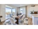 Bright dining area with a large window and sliding glass door that leads to an outdoor patio at 4108 Estrella St, Brighton, CO 80601