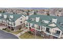 Inviting townhome featuring a private balcony, manicured lawn and a peek at mountain views in the background at 1825 Spaulding Cir, Superior, CO 80027