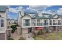 Charming townhouse with covered balcony, attached garage, and well-maintained landscaping for a welcoming curb appeal at 1825 Spaulding Cir, Superior, CO 80027