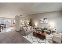 Staged living room with 2 couches, neutral walls, modern decor and carpeting at 292 S Pembrook St, Castle Rock, CO 80104