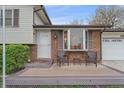 Inviting front porch with seating area and decorative front door at 5060 W 71St Pl, Westminster, CO 80030