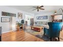 Bright living room features hardwood floors, ceiling fan, and stylish decor for comfortable living at 1395 S Kendall St, Lakewood, CO 80232