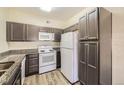 Efficient kitchen with appliances, granite countertops, and ample cabinet space at 1148 Opal St # 101, Broomfield, CO 80020
