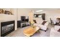 Cozy living room with fireplace, plush seating, and ample natural light at 1148 Opal St # 101, Broomfield, CO 80020