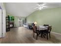 Bright living room with wood floors, a fireplace, and dining area at 23 Shetland Ct, Highlands Ranch, CO 80130