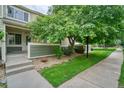 Charming townhome featuring mature trees and a well-manicured front yard at 930 Button Rock Dr # 29, Longmont, CO 80504