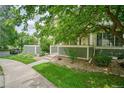 Well-maintained townhome with a sidewalk and lush greenery at 930 Button Rock Dr # 29, Longmont, CO 80504