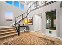 Bright and inviting foyer with high ceilings, modern staircase, and hardwood floors at 19495 W 94Th Ave, Arvada, CO 80007