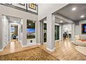Spacious living room featuring hardwood floors and seamless access to the outdoor spaces at 19495 W 94Th Ave, Arvada, CO 80007