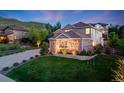 Charming two-story brick home with manicured lawn and professional landscaping at 5364 Dunraven Cir, Golden, CO 80403