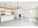 Open concept living area with a modern fireplace, stylish lighting, and access to the kitchen at 5788 N Killarney Way, Aurora, CO 80019