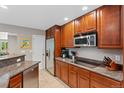 Spacious kitchen boasts stainless steel appliances, granite countertops and ample custom wood cabinetry at 6143 S Ash E Cir, Centennial, CO 80121