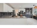 Modern kitchen with granite countertops, stainless steel appliances, and stylish backsplash at 23709 Glenmoor Dr, Parker, CO 80138