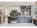 Well-equipped kitchen featuring stainless steel appliances, stylish backsplash and tile flooring at 23709 Glenmoor Dr, Parker, CO 80138