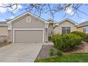 Inviting home with a two-car garage, stone accents, and a well-maintained front yard at 22312 E Plymouth Cir, Aurora, CO 80016