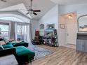 Bright living room featuring vaulted ceilings, hardwood floors, and a green sectional sofa at 14221 E 1St Dr # 304, Aurora, CO 80011