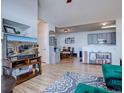 Open living room with hardwood floors and views into the kitchen and dining area at 14221 E 1St Dr # 304, Aurora, CO 80011