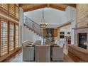 Elegant dining room featuring a wooden table, modern chairs, and an iron staircase at 7088 Indian Peaks Trl, Boulder, CO 80301