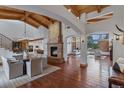 Spacious living room with wood floors, a stone fireplace, and vaulted ceilings at 7088 Indian Peaks Trl, Boulder, CO 80301