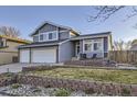 Charming two-story home with blue siding, brick accents, and well-maintained front yard landscaping at 3801 S Joplin St, Aurora, CO 80013