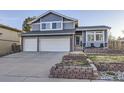 Charming two-story home with blue siding, brick accents, and well-maintained front yard landscaping at 3801 S Joplin St, Aurora, CO 80013