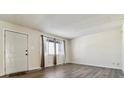 Bright living room features new floors, and a large window allowing for ample natural light at 14830 Robins Dr, Denver, CO 80239