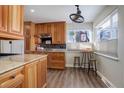 Bright kitchen with wood cabinets, granite counters, and breakfast nook at 3300 E Briarwood Ave, Centennial, CO 80122