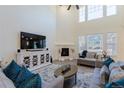 Bright living room with a fireplace and large windows providing natural light at 8240 S White Crow St, Aurora, CO 80016