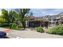 Community clubhouse with well-kept landscaping, seating and path at 12711 Colorado Blvd # 1116, Thornton, CO 80241