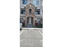 Attractive condo entrance featuring stone archway and well-maintained landscaping at 12711 Colorado Blvd # 1116, Thornton, CO 80241