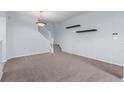Living room area with staircase and views to other parts of the house at 12711 Colorado Blvd # 1116, Thornton, CO 80241