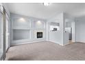 Inviting living room features a cozy fireplace, modern lighting, and convenient kitchen access at 12711 Colorado Blvd # 1116, Thornton, CO 80241