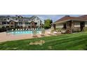 Community pool area with lots of seating and green grass at 12711 Colorado Blvd # 1116, Thornton, CO 80241