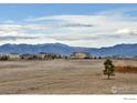 Scenic view of the majestic Rocky Mountains from a community with sprawling grasslands at 4220 Kestrel Dr, Broomfield, CO 80023