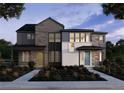 Two-story modern home with stone and siding accents, landscaping, and two-car garage at 7210 Watercress Dr, Littleton, CO 80125