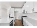 White kitchen with stainless steel appliances and an island at 7210 Watercress Dr, Littleton, CO 80125