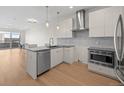 Contemporary kitchen featuring sleek cabinetry, stainless steel appliances, and an eat-in island at 1616 S Broadway # 206, Denver, CO 80210