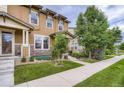 Attractive townhome featuring manicured front yard and a welcoming facade at 1519 S Dayton St, Denver, CO 80247