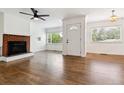 Inviting living room featuring hardwood floors, brick fireplace, and natural light at 2731 S Pearl St, Englewood, CO 80113