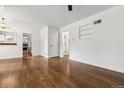 Spacious room with hardwood floors, white walls and trim with views into kitchen at 2731 S Pearl St, Englewood, CO 80113