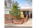 Charming single-story home with wooden deck and brick accents, and a quaint landscaped front yard at 945 Waite Dr, Boulder, CO 80303