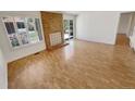 Bright and airy living room featuring wood floors and a cozy fireplace at 3986 S Bahama St, Aurora, CO 80013