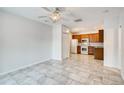 Open-concept kitchen with tile flooring, stainless steel appliances, and wooden cabinetry at 3818 W 14Th Ave, Denver, CO 80204