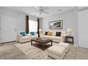 Bright living room featuring neutral furniture, ceiling fan and tasteful decor with tile flooring at 3818 W 14Th Ave, Denver, CO 80204