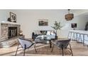 Cozy living room with a brick fireplace and an open layout leading to the kitchen at 4294 S Salida Way # 4, Aurora, CO 80013