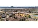 Scenic aerial view of a neighborhood with lush trees, pool, mountains, and multi-Gathering housing at 8422 S Upham Way # G47, Littleton, CO 80128