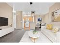 Open-concept living room with updated kitchen and dining space, perfect for modern living at 8422 S Upham Way # G47, Littleton, CO 80128
