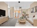 Inviting living room showcasing open-concept design with adjacent kitchen and dining areas for seamless entertaining at 8422 S Upham Way # G47, Littleton, CO 80128